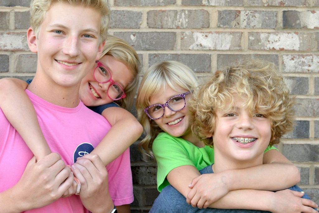 Siblings smiling with braces
